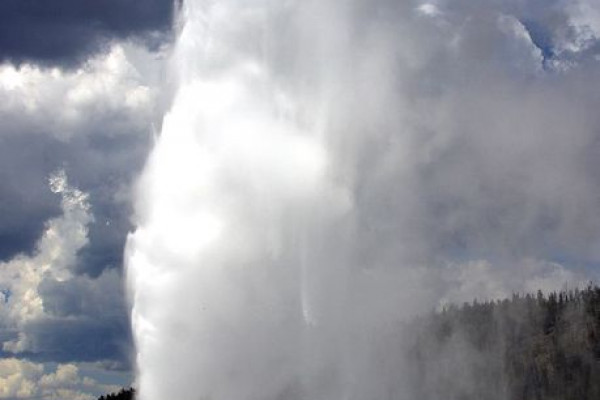 Old Faithful geyser in Yellowstone National Park, USA