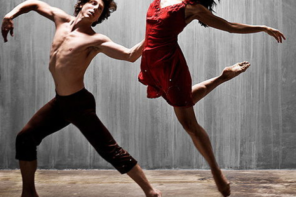 A man and a woman performing a modern dance.