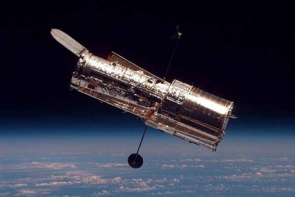 The Hubble Space Telescope (HTS) begins its separation from Space Shuttle Discovery following its release on mission STS-82.