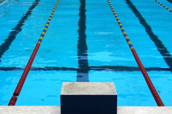 View from the starting block of a competition swimming pool.