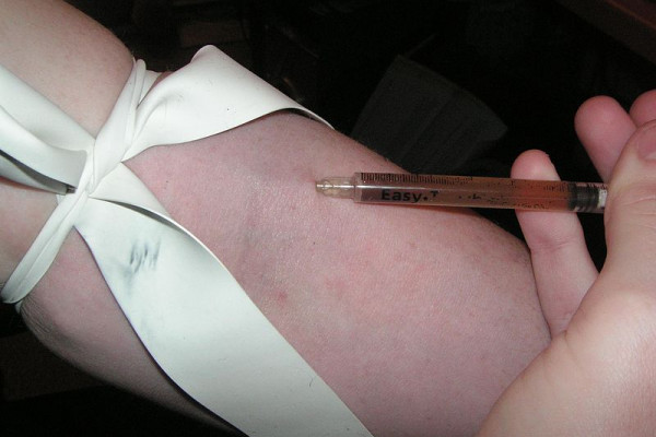 Injecting heroin intravenously