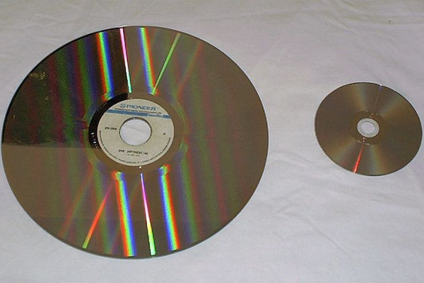 A laserdisc (left) compared with a DVD (right).