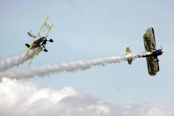 The UK Utterly Butterly display team perform an aerobatic manoeuvre with their Boeing Stearmans, at an air display in England.