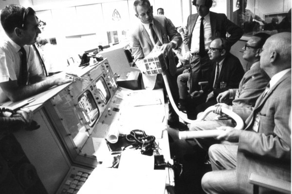  Deke Slayton (check jacket) shows the adapter devised to make use of square Command Module lithium hydroxide canisters to remove excess carbon dioxide from the Apollo 13 LM cabin. As detailed in Lost Moon by Jim Lovell and Jeffrey Kluger, the adapter...