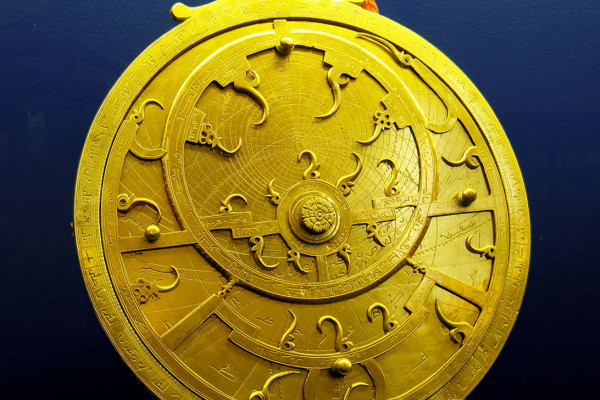  An 18th Century Persian astrolabe - maker unknown. The points of the curved spikes on the front ''rete'' plate, mark the positions of the brightest stars. The name of each star being labeled at the base of each spike. The back plate, or ''mater'' is...