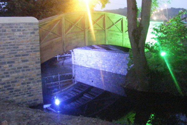 Bella's Bridge over the Whitelake River, on the site of the Glastonbury Festival. Illuminated with coloured lights