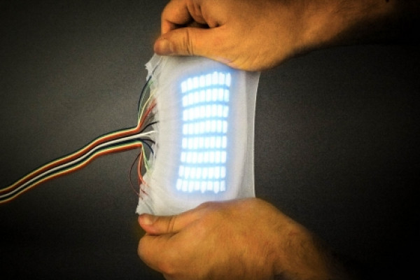 A highly stretchable electroluminescent skin capable of stretching to nearly six times its original size while still emitting light.