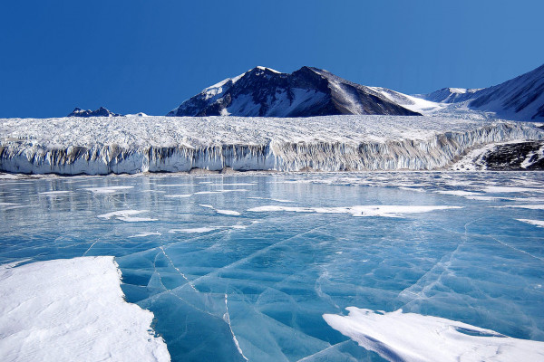 Antarctica: The blue ice covering Lake Fryxell, in the Transantarctic Mountains, comes from glacial meltwater from the Canada Glacier and other smaller glaciers. The freshwater stays on top of the lake and freezes, sealing in briny water below.