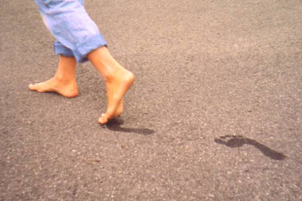 Healthy feet of an 11-year-old girl who regularly goes barefoot. Note the presence of ideal arches, looking at her footprints on the dirty floor.