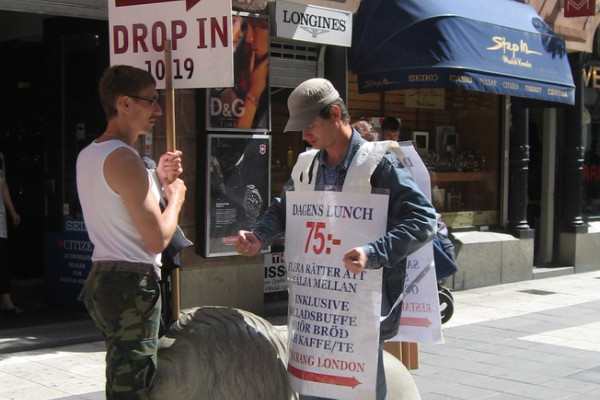 Two human billboards in Drottninggatan, Stockholm.