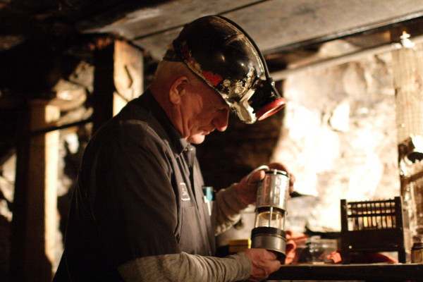 Tour guide at the Beckley WV Exhibition Coal Mine, showing the kind of safety lamp that replaced canaries as methane detectors.