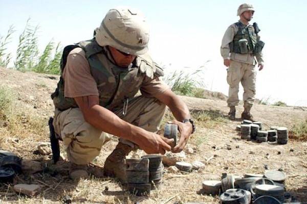  U.S. Army Sgt. Kirk Medina, from 759th Explosive Ordinance Disposal, out of Fort Erwin, Calif., attached to the 3rd Infantry Division (Mechanized), removes fuse from a Russian-made mine, while working together with soldiers from A Company, 10...