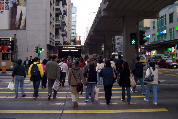 Pedestrians cross a road in Mong Kok.