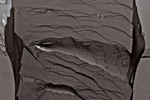 Secondary electron micrographs taken after a bending test on an unnotched Pd79Ag3.5P6Si9.5Ge2 glassy specimen. The sample did not fracture catastrophically after undergoing the entire bending strain applicable by the fixture.