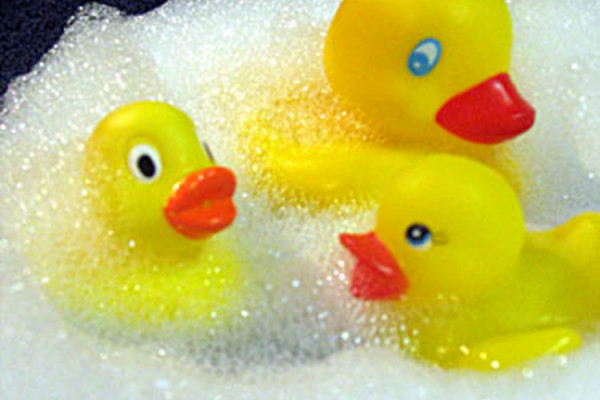 Three yellow rubber ducks play in the bubble bath!