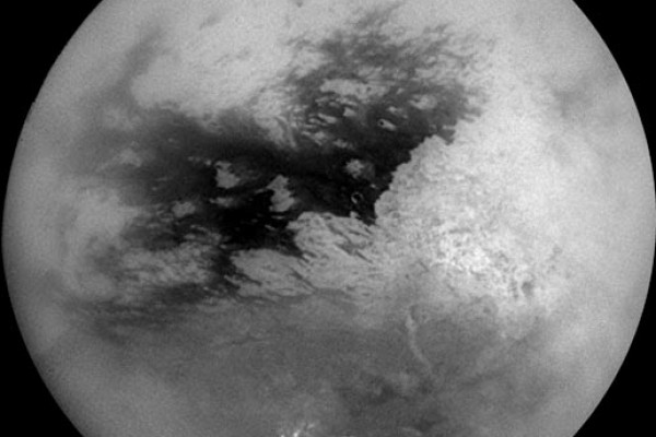 The Cassini orbiter used special optical systems to pierce Titans smog revealing bright continents, dark plains and methane clouds around the South Pole
