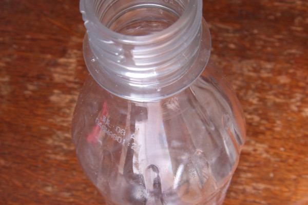A water vortex in two soda bottles joined vertically.