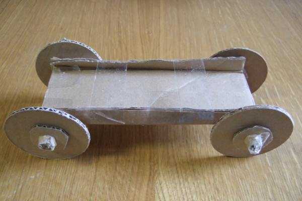 A car with a small axle made out of toilet roll cardboard
