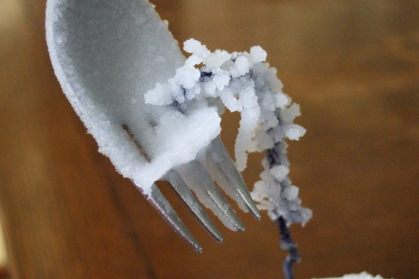 Sodium carbonate crystals growing on a fork.