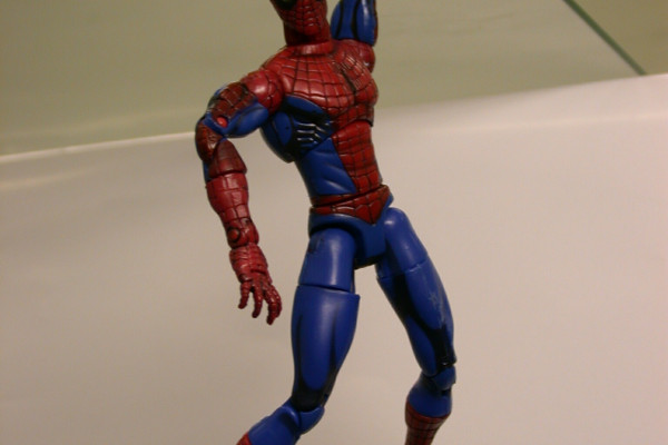 Figure 1b: Spiderman toy hanging from a glass plate, attached using the Gecko-tape. The contact area is about 0.5cm2 with a carry load of >100g. This toy has been attached to several surfaces before this photo was taken.