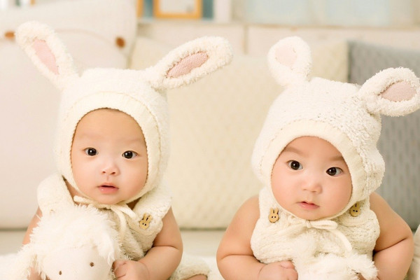 Twin babies in bunny outfits.