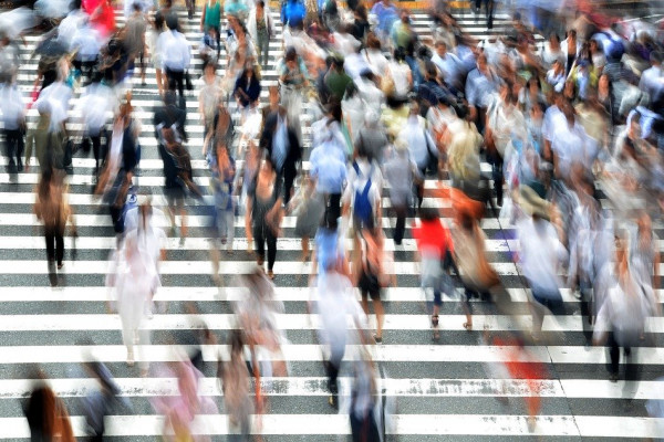 A crowd of people blurred from motion.