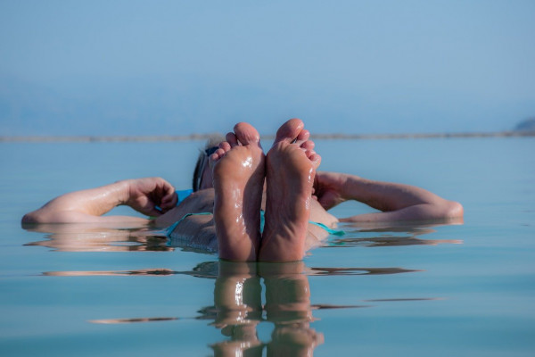 A person floats on the hypersaline water in the Dead Sea