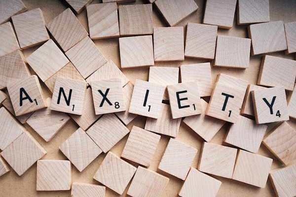 The word 'anxiety' spelled out in scrabble tiles.