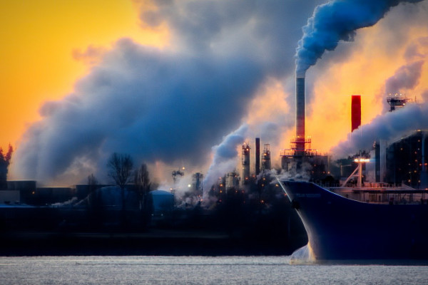 Smoke emissions and air pollution from an industrial landscape.
