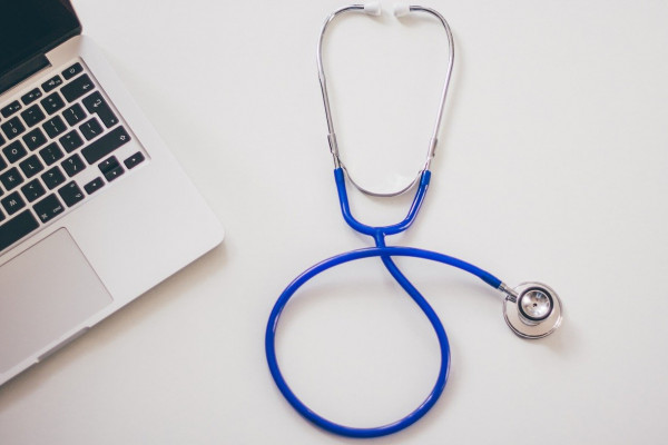 image of a stethoscope and a laptop computer