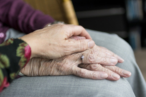 The hands of an elderly couple.