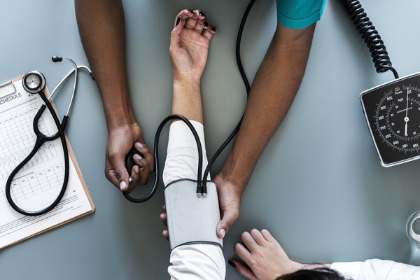 A patient's blood pressure being tested by a doctor.