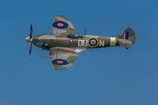 A spitfire aeroplane, flying through the air