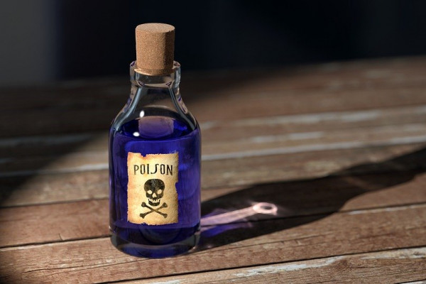 A bottle marked with a skull and crossbones, and the word poison, containing a dark purple liquid