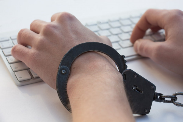 A person chained to a computer