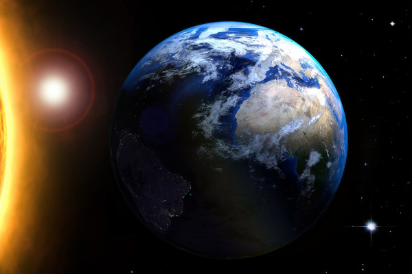 The Earth in space orbiting round the sun.