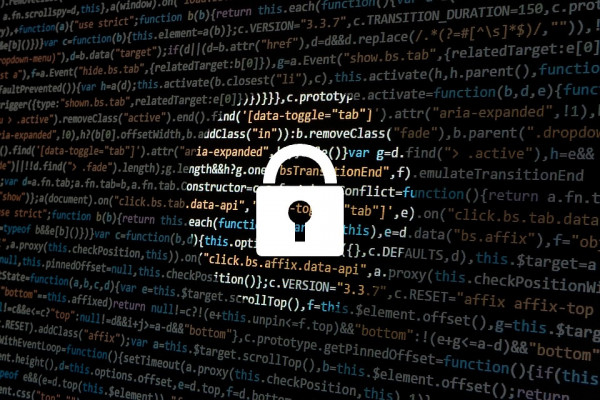 A padlock imposed over a screen of computer code