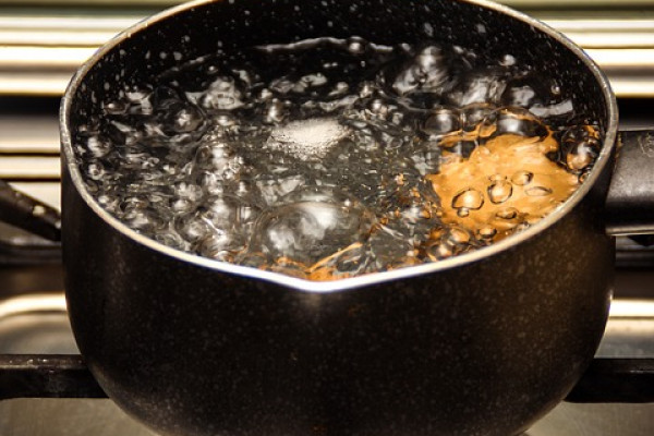 A pot of boiling water on a stove