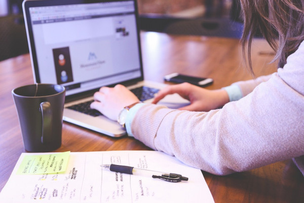 Person working at a computer to a deadline