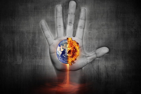 Cartoon hand holding a burning Earth