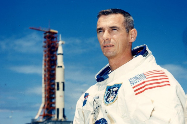 Astronaut Gene Cernan in front of a rocket