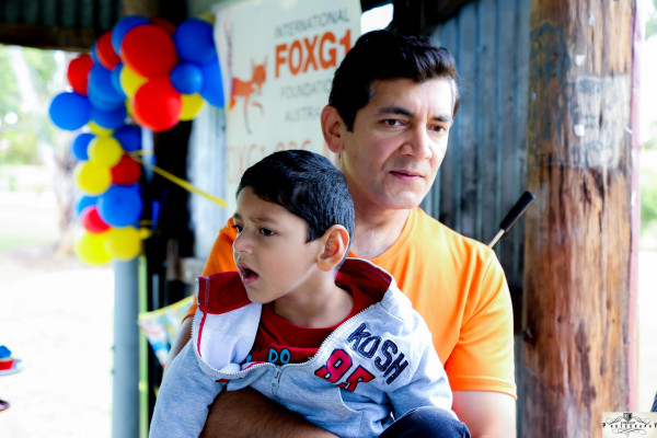 Kushagra Singha, a child with FOXG1 Syndrome, with his father Vivek.