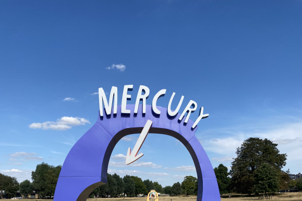 Purple arch with the word "Mercury" on top pointing to a tiny pea-sized planet