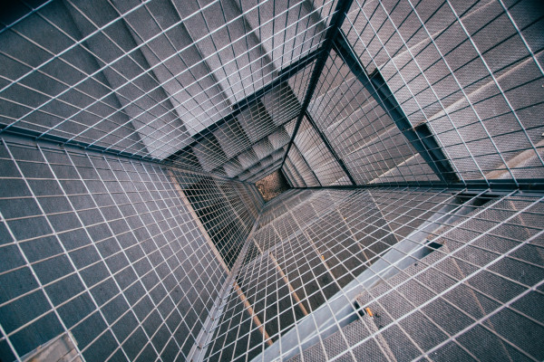 Aerial view of square spiral staircase with metal mesh