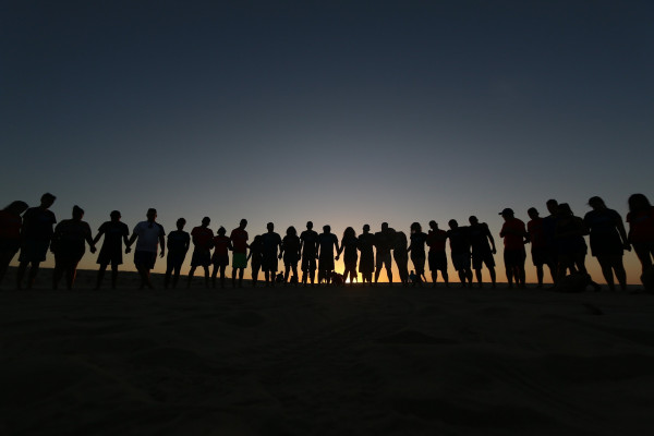 A group of people standing hand in hand