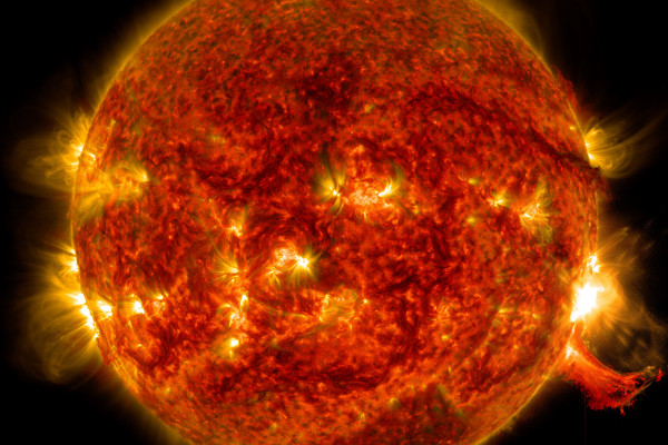 NASA's Solar Dynamics Observatory captured this image of a solar flare on Oct. 2, 2014. The solar flare is the bright flash of light on the right limb of the sun. A burst of solar material erupting out into space can be seen just below it.
