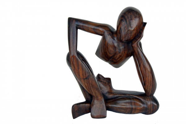 Wooden carving of a person thinking