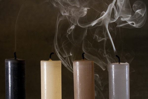 The image shows smoke rising from a candle.