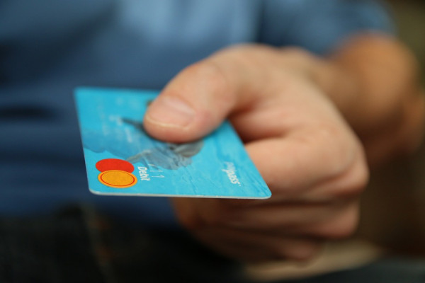 Person holding a blue bank card