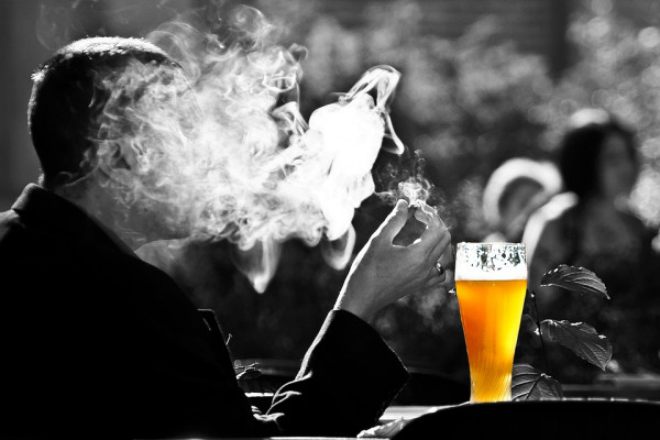 A smoker enjoying a pint of beer